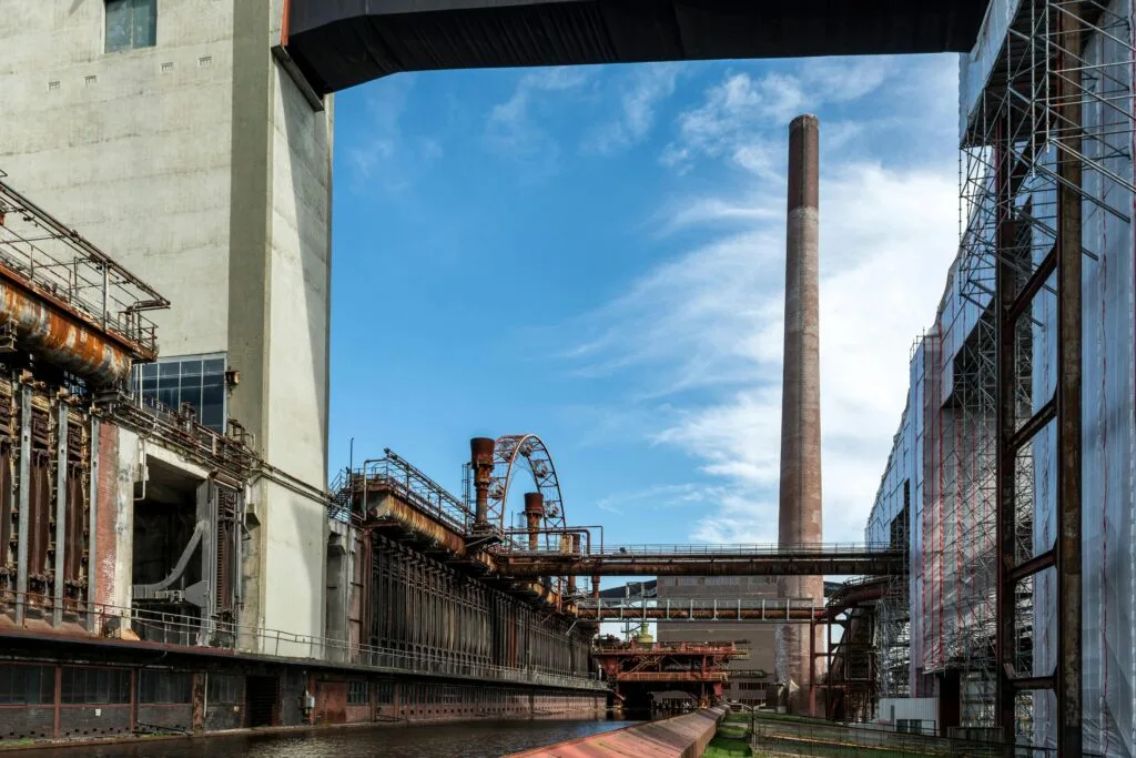 View of Zollverein industrial site, showcasing historical steel architecture under a clear blue sky.